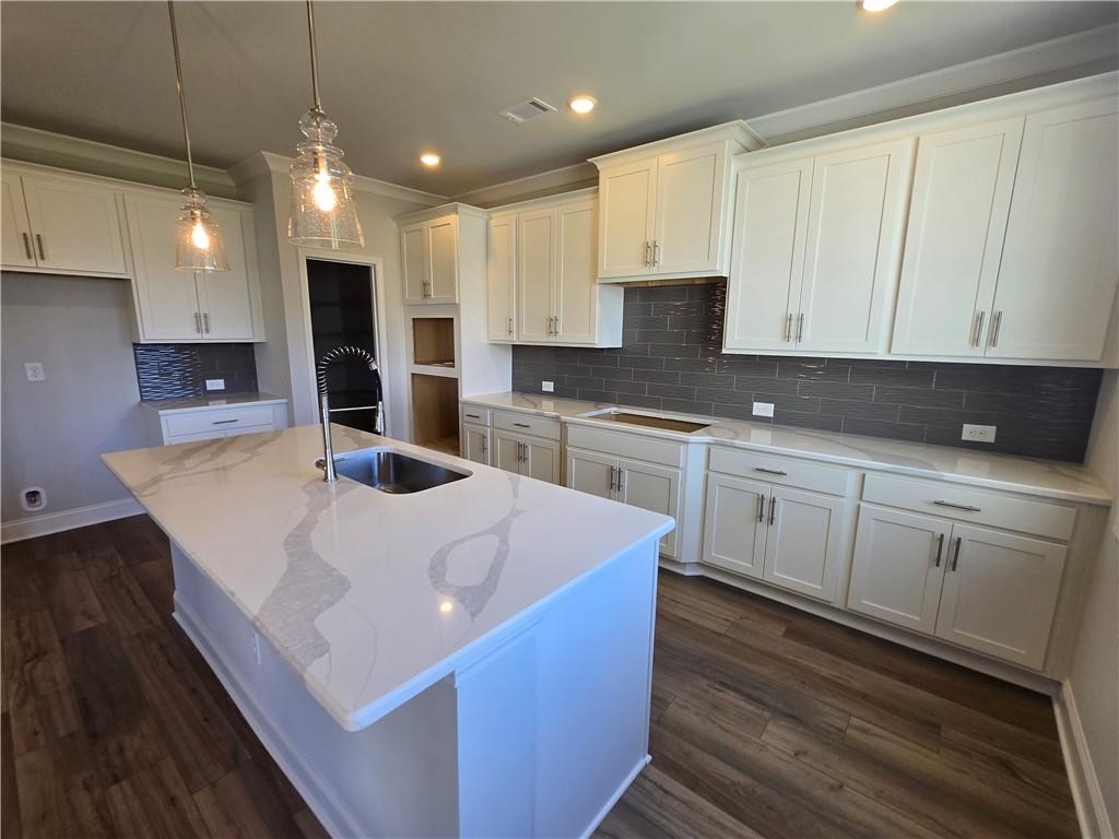 304 Westfall Terrace Loganville, GA 30052 - Photo 15 of 50 a kitchen with stainless steel appliances a sink a stove a microwave and cabinets
