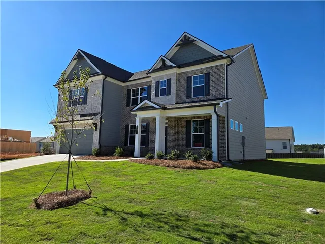a front view of a house with a yard