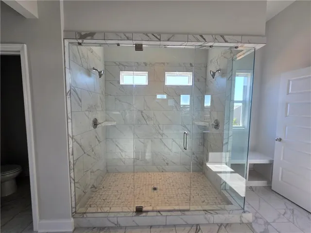 a bathroom with a glass shower door
