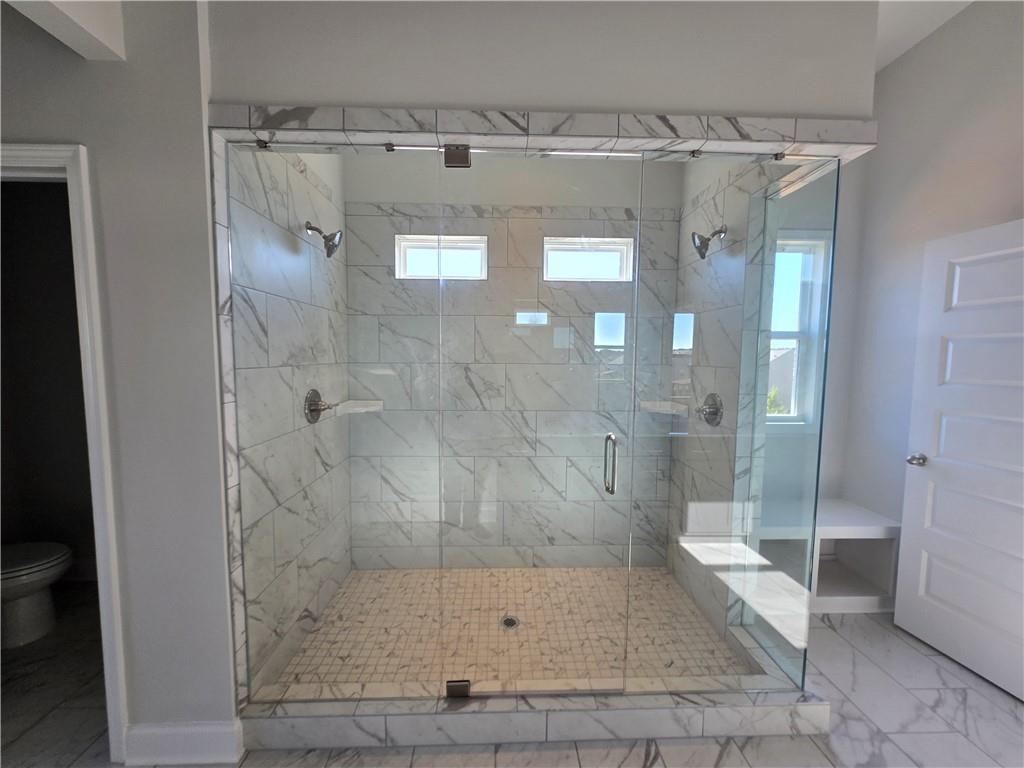 304 Westfall Terrace Loganville, GA 30052 - Photo 26 of 50 a bathroom with a glass shower door