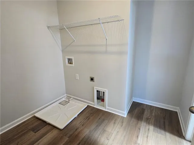 a view of an empty room and wooden floor