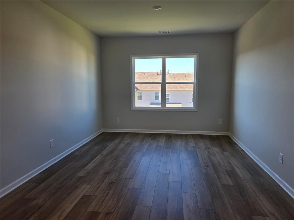 304 Westfall Terrace Loganville, GA 30052 - Photo 29 of 50 an empty room with wooden floor and windows