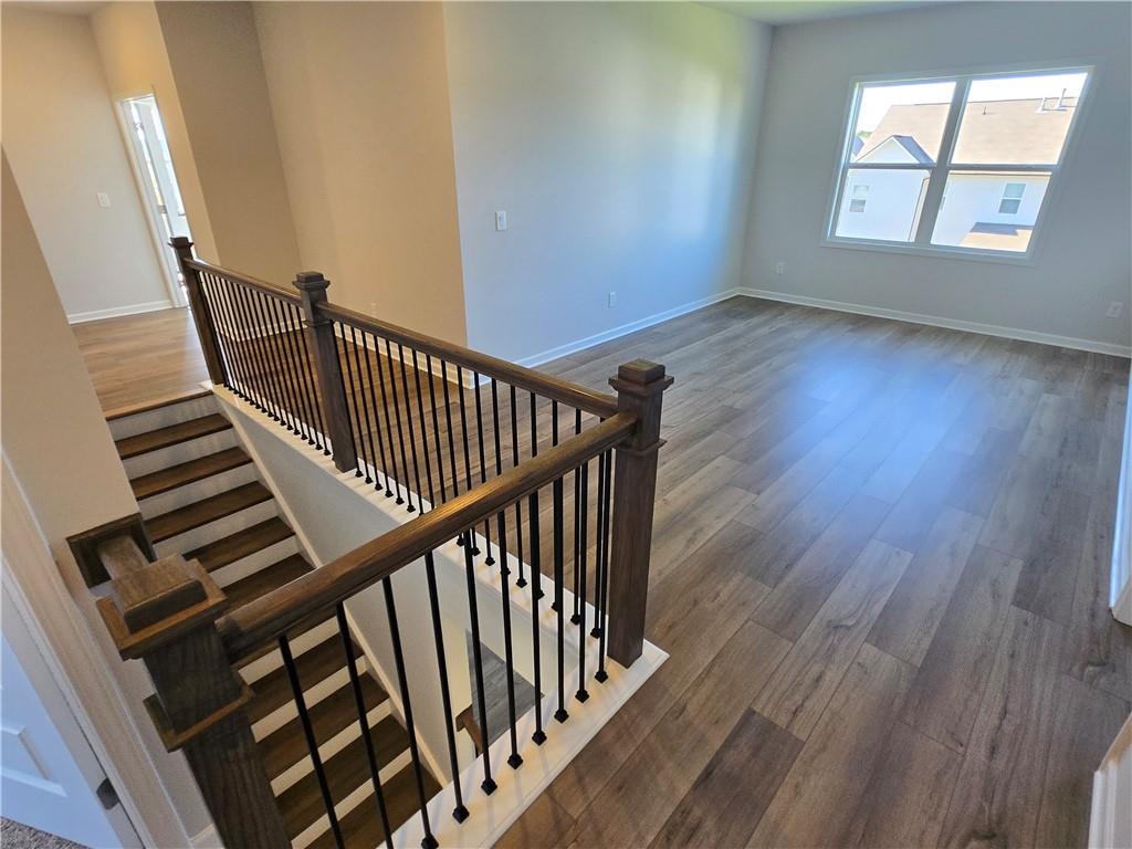 304 Westfall Terrace Loganville, GA 30052 - Photo 30 of 50 a view of staircase with wooden floor and white walls