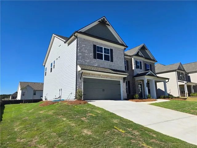 a front view of a house with a yard