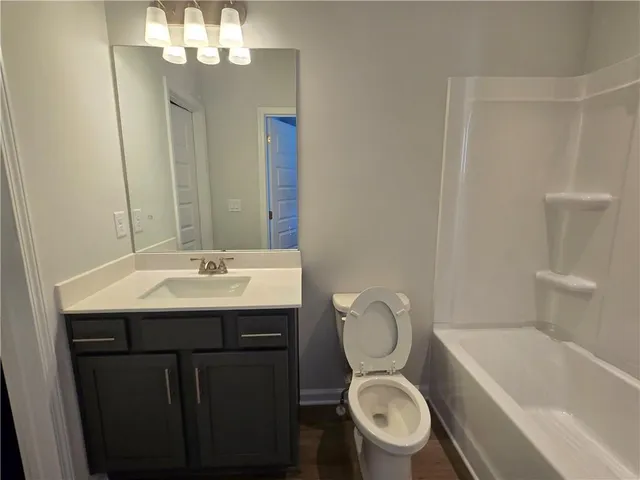 a bathroom with a toilet a sink and bathtub