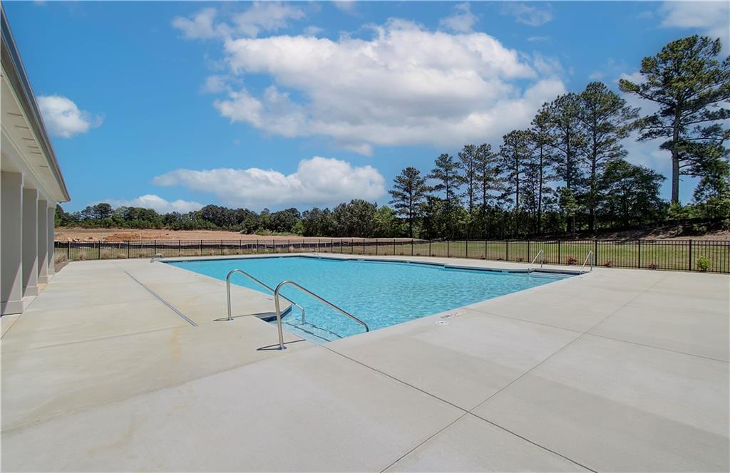 304 Westfall Terrace Loganville, GA 30052 - Photo 41 of 50 a view of swimming pool with seating space and wooden fence