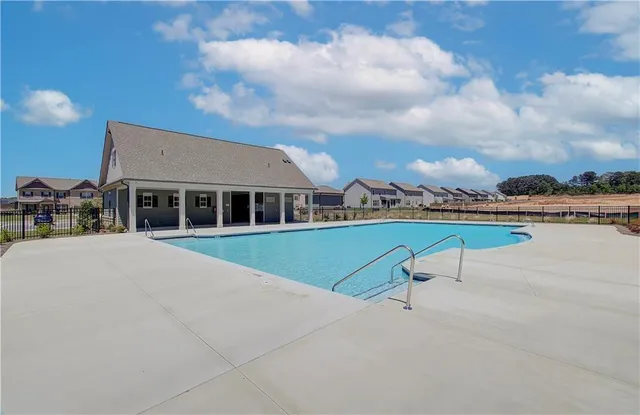a view of multiple houses with a swimming pool