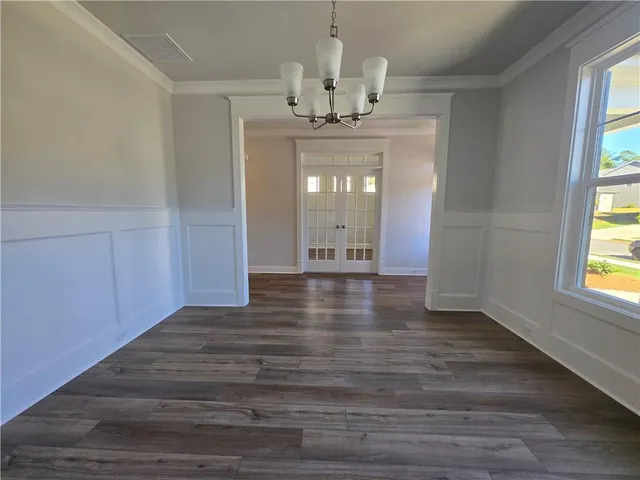 a view of an entryway with wooden floor and a chandelier