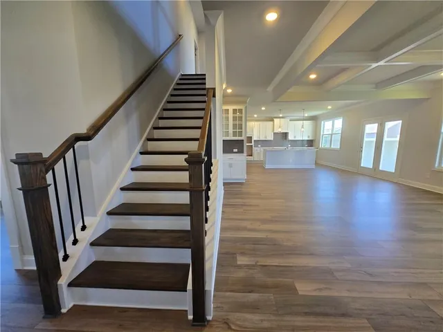 a view of entryway and hall with wooden floor