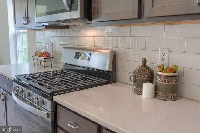 a stove top oven sitting inside of a kitchen