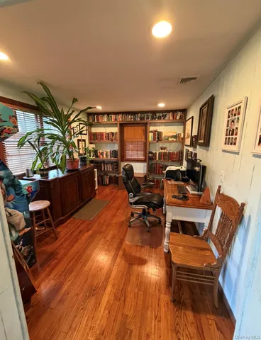 a bed sitting in a bedroom next to a book shelf