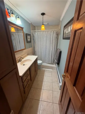 a bedroom with a bed window and dresser