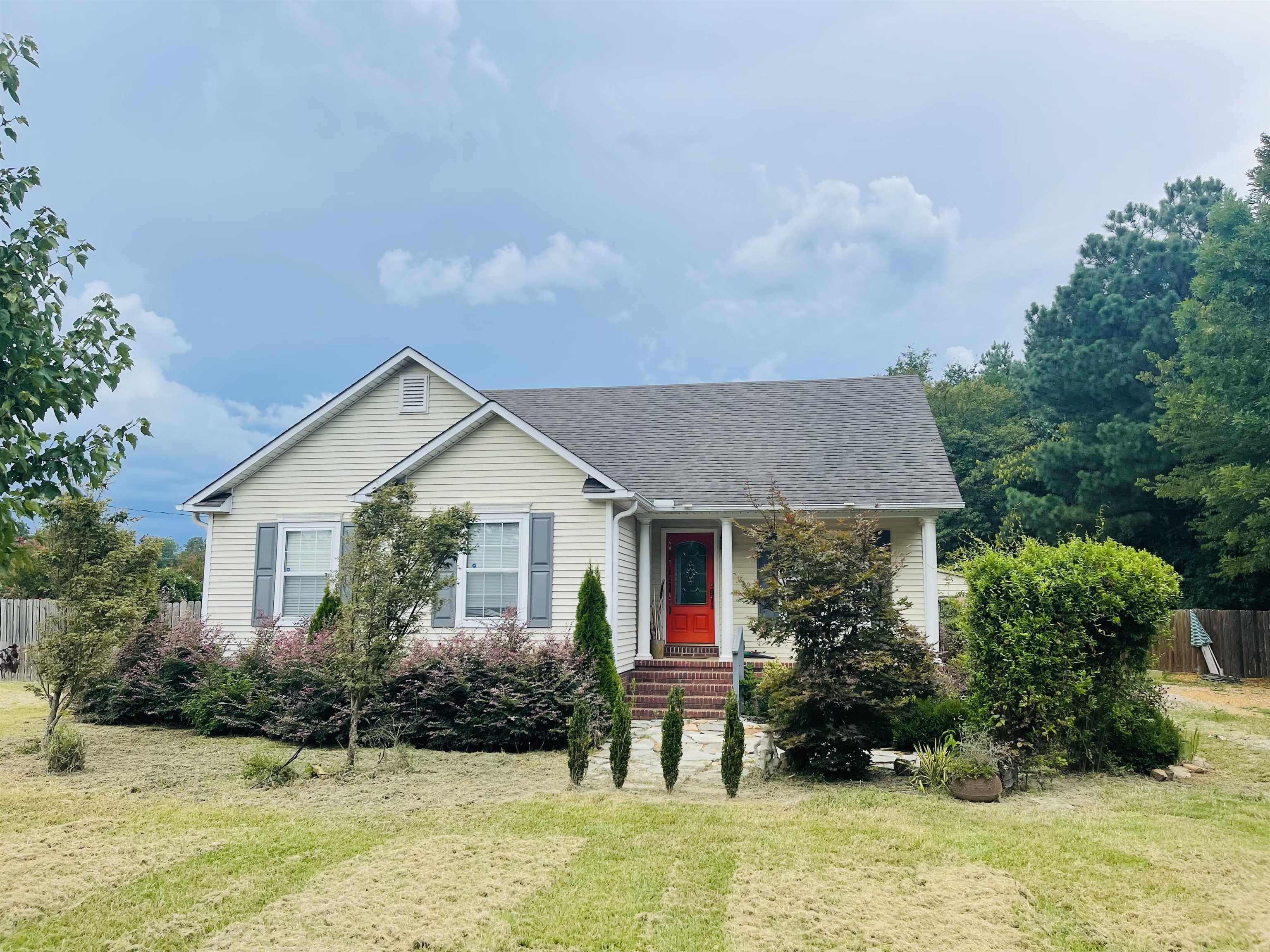 a front view of house with yard and green space