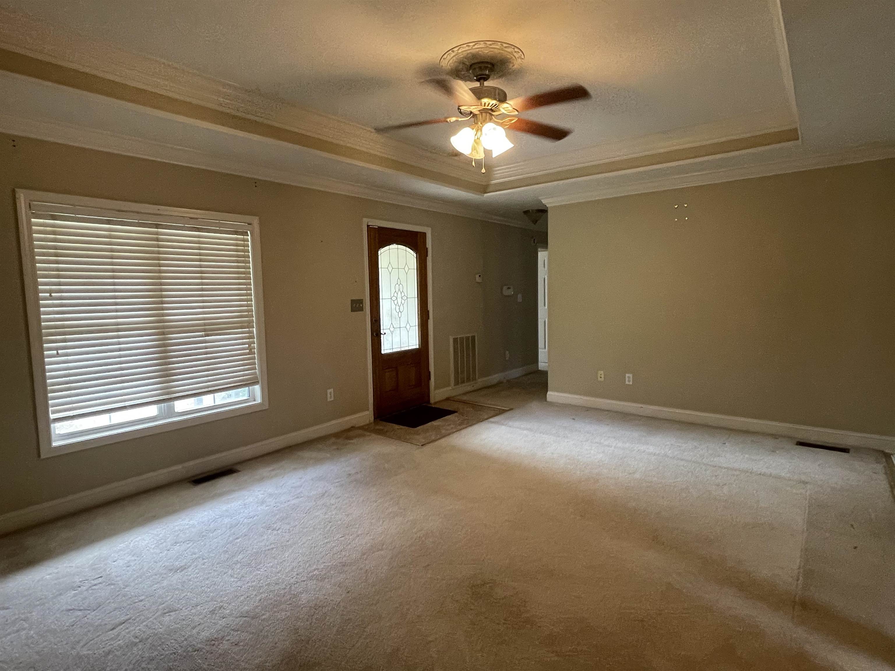 50 Eric Lane West Ramer, TN 38367 - Photo 2 of 19 an empty room with chandelier fan and windows
