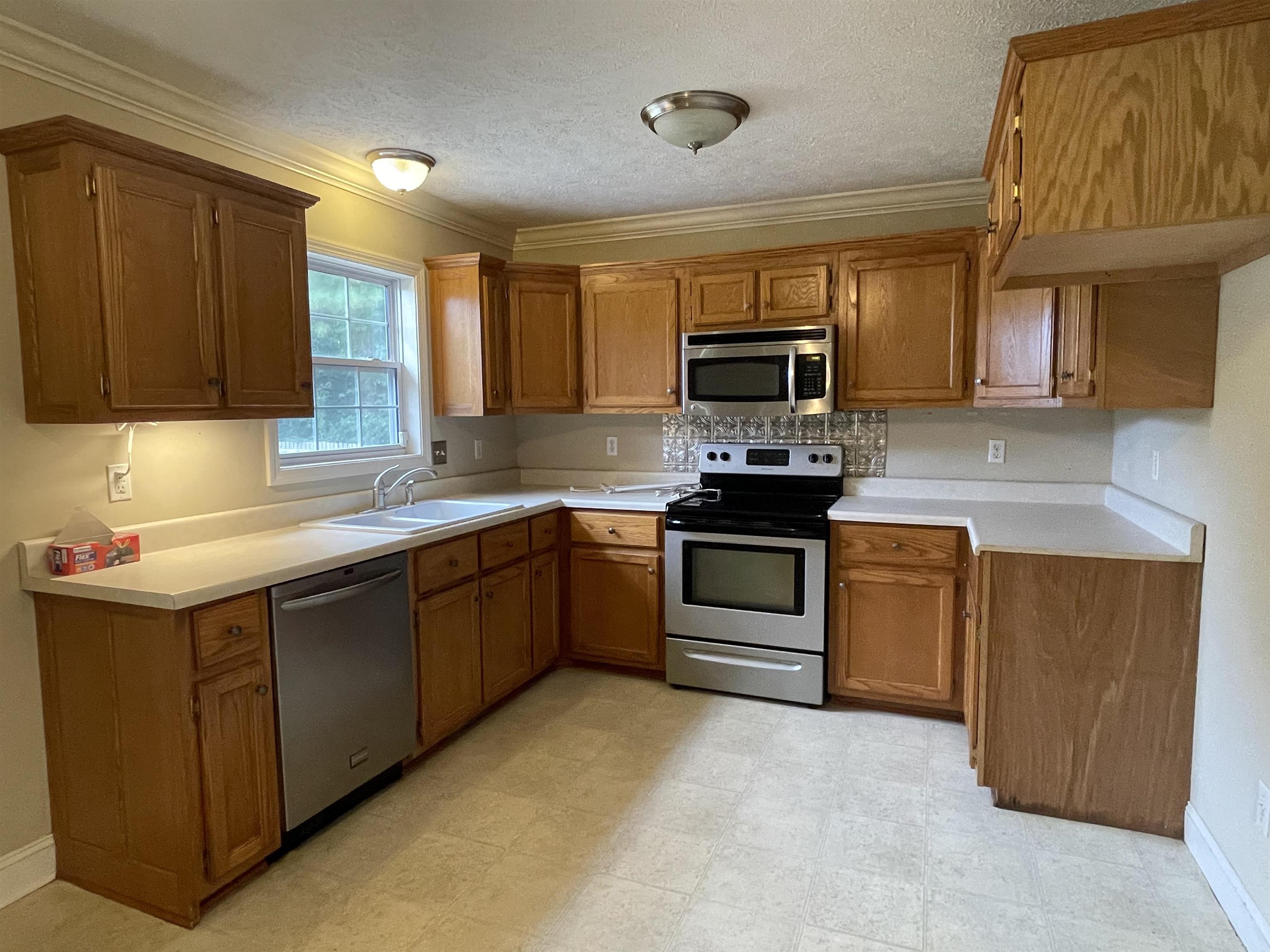 50 Eric Lane West Ramer, TN 38367 - Photo 5 of 19 a kitchen with a sink stove top oven and granite counter top