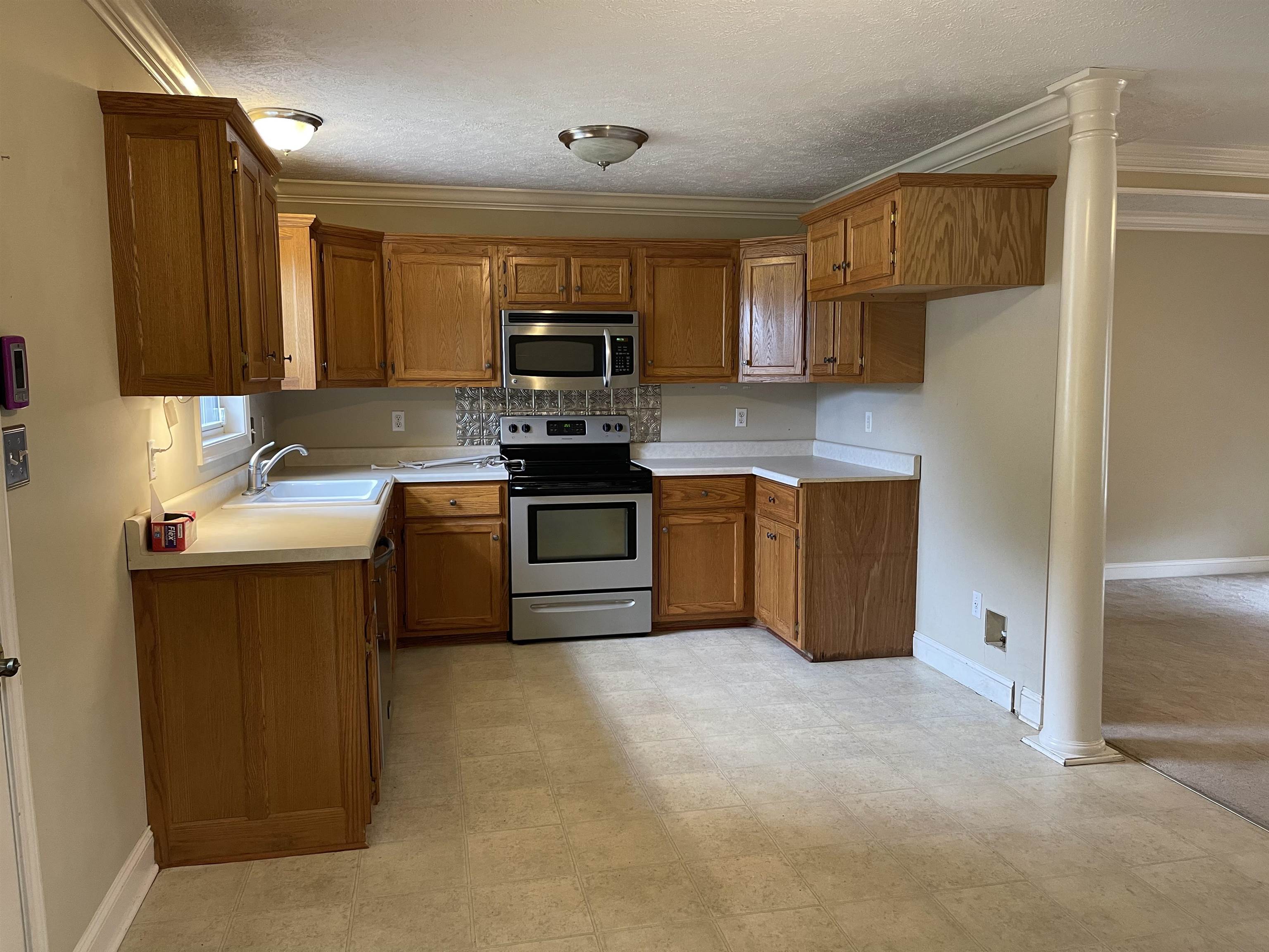50 Eric Lane West Ramer, TN 38367 - Photo 6 of 19 a kitchen with stainless steel appliances granite countertop a sink stove refrigerator and microwave