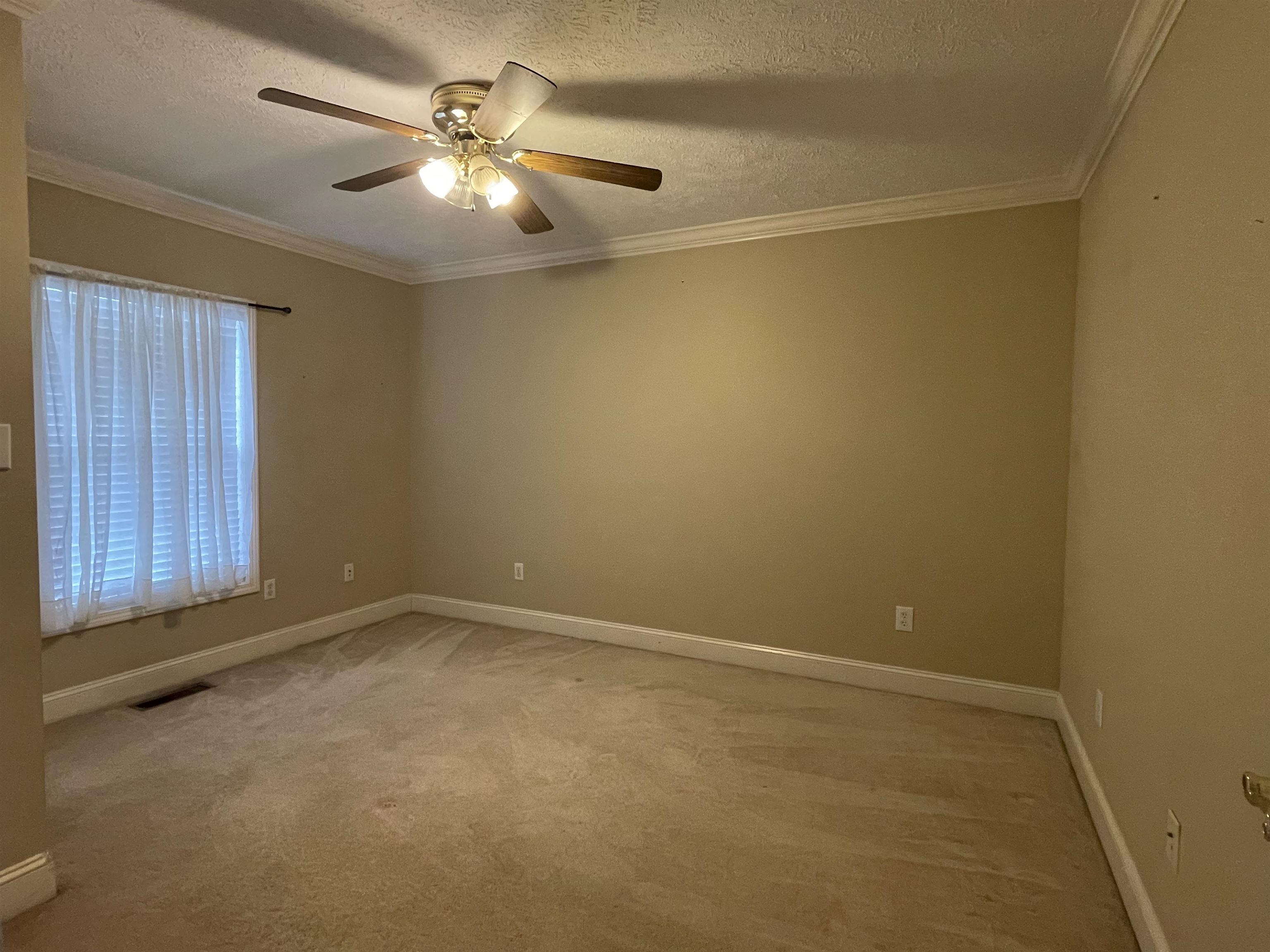 50 Eric Lane West Ramer, TN 38367 - Photo 10 of 19 an empty room with a chandelier fan and windows