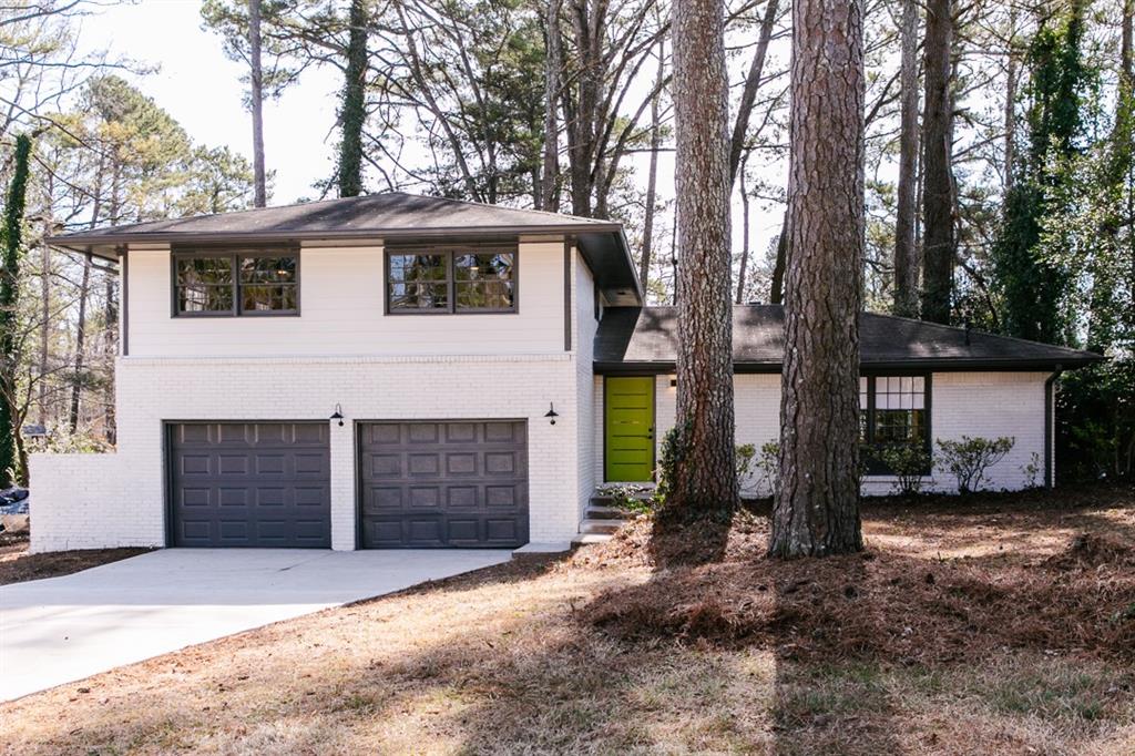 3489 Oregon Trail Decatur, GA 30032 - Photo 1 of 1 a front view of a house with a yard and garage