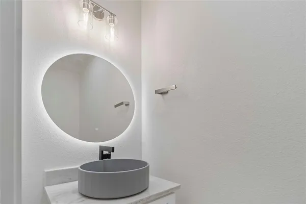 a bathroom with a sink and mirror