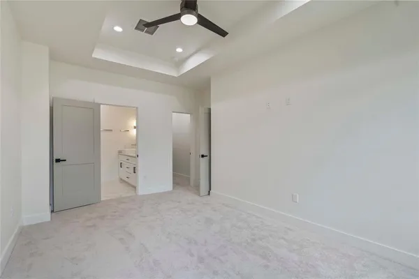 an empty room with fan and entrance