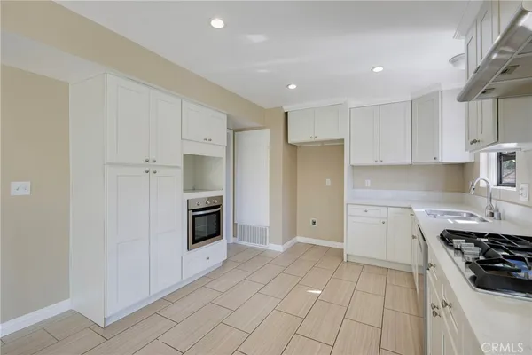 a kitchen with stainless steel appliances a stove a sink and a refrigerator