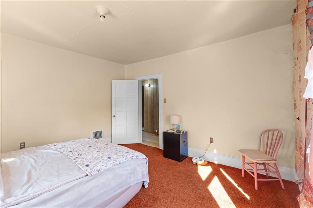 801 Bower Hill Road Bridgeville, PA 15017 - Photo 16 of 34 a bedroom with a bed and chair