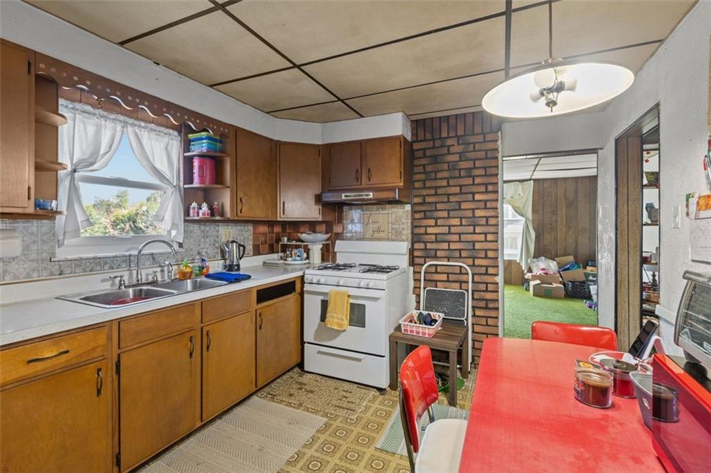 801 Bower Hill Road Bridgeville, PA 15017 - Photo 7 of 34 a kitchen with a sink appliances cabinets and furniture