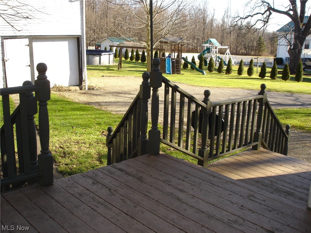 18245 Madison Road Middlefield, OH 44062 - Photo 30 of 37 Back deck looking onto play set and pool. Pole barn to the left.