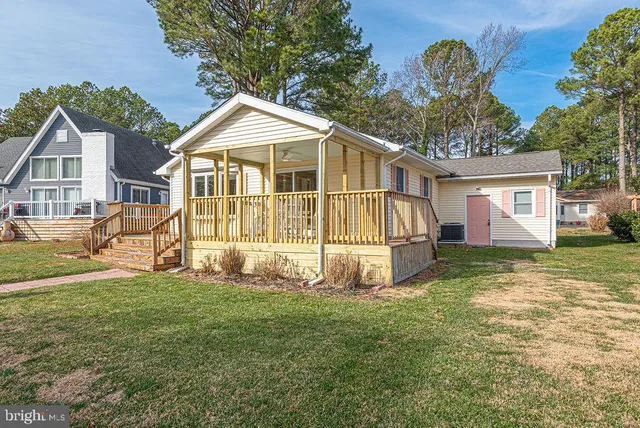 a view of a house with a yard and sitting area