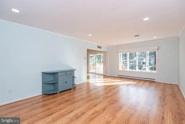 wooden floor in an empty room with a window
