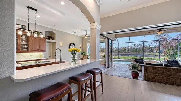 a kitchen with a stove and wooden floor
