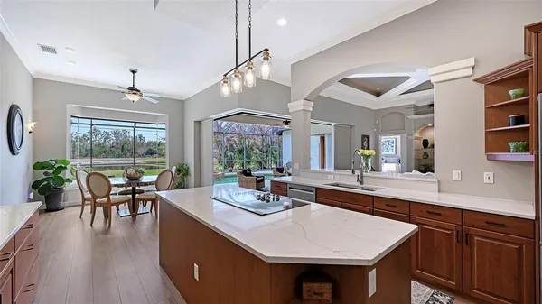 a dining room with furniture potted plants and wooden floor