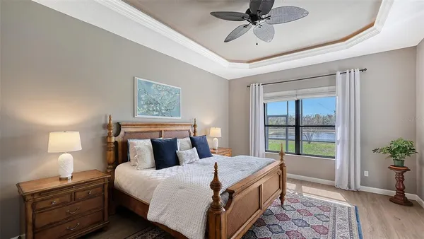 a bedroom with a bed and a chandelier