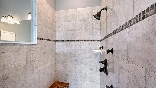 a spacious bedroom with a bed and a chandelier