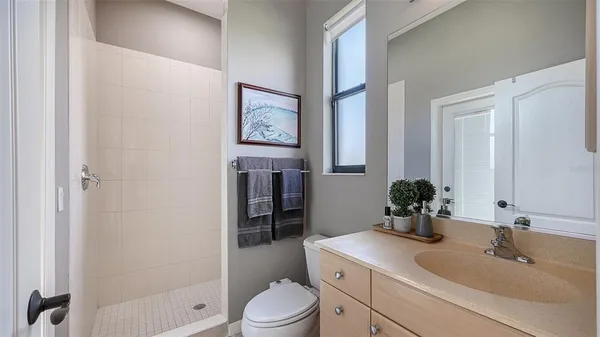 a bathroom with a sink toilet and shower