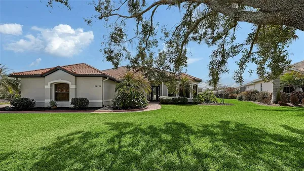 a front view of house with yard and green space