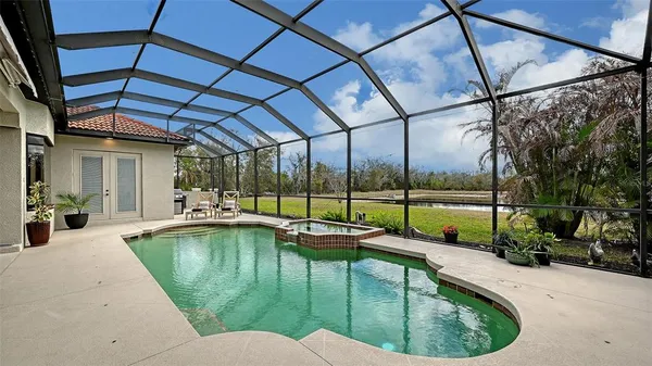 a view of a backyard with a patio and swimming pool