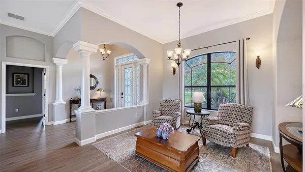 a living room with furniture and a chandelier