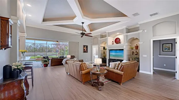 a living room with fireplace furniture and a wooden floor