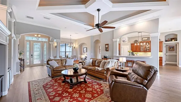 a living room with furniture and a chandelier