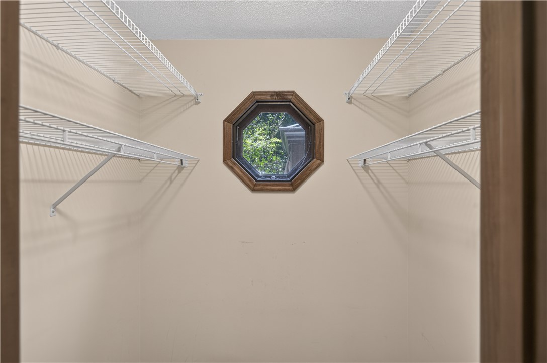 103 Dorsey Lane Walhalla, SC 29691 - Photo 19 of 42 An octagonal window provides an architectural focal point in this organized closet with ample wire shelving.
