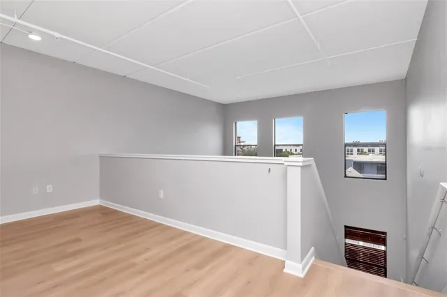 a view of a kitchen with wooden floor and electronic appliances