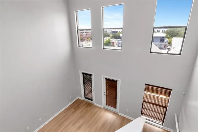 a view of empty room with windows and wardrobe