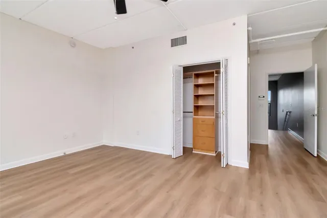 a view of empty room with wooden floor