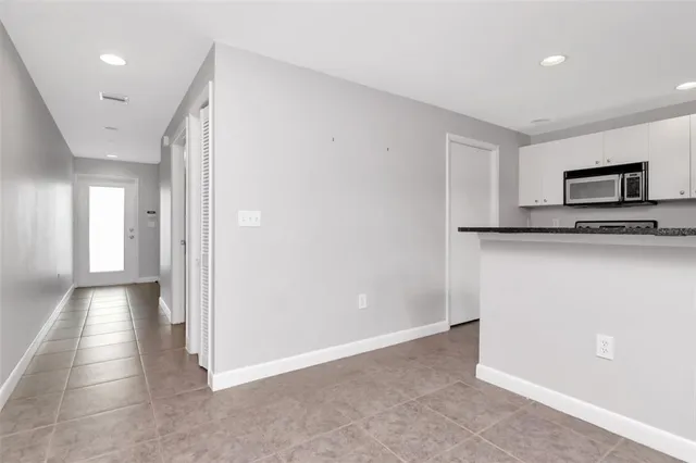 a view of a kitchen with a sink and a refrigerator