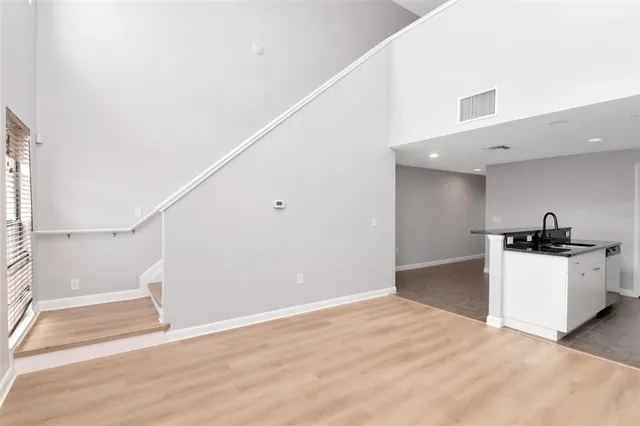 a view of a kitchen with wooden floor and electronic appliances