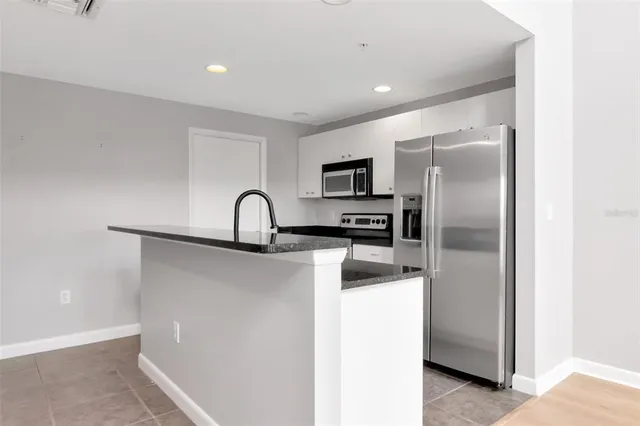 a kitchen with a refrigerator and a sink