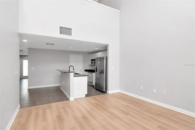 a kitchen with a refrigerator and a sink