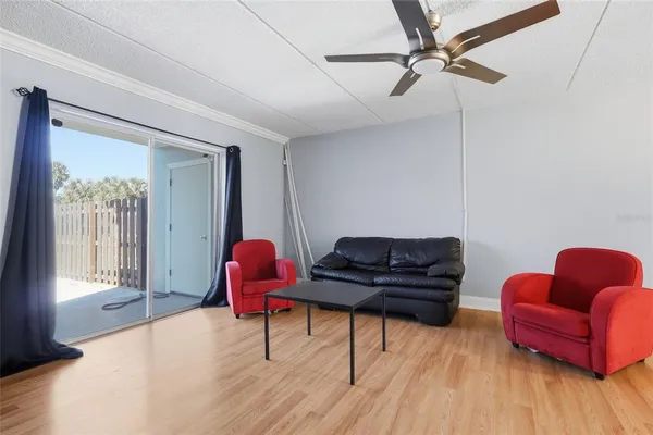 a living room with furniture and wooden floor