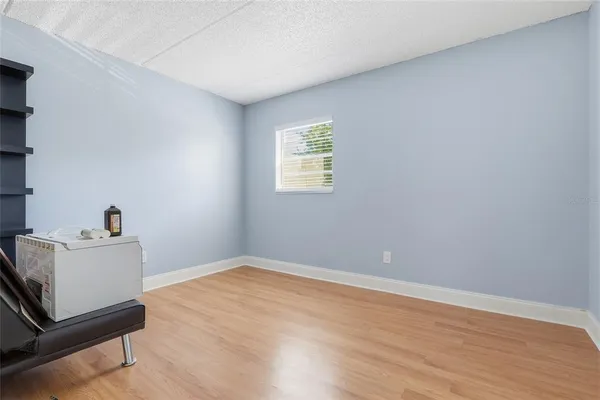 a view of a room with wooden floor and white walls